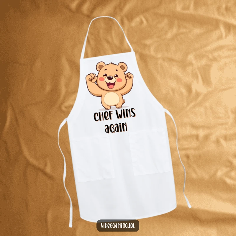 Funny apron showing a happy bear pumping its fist in the air, celebrating a kitchen victory.