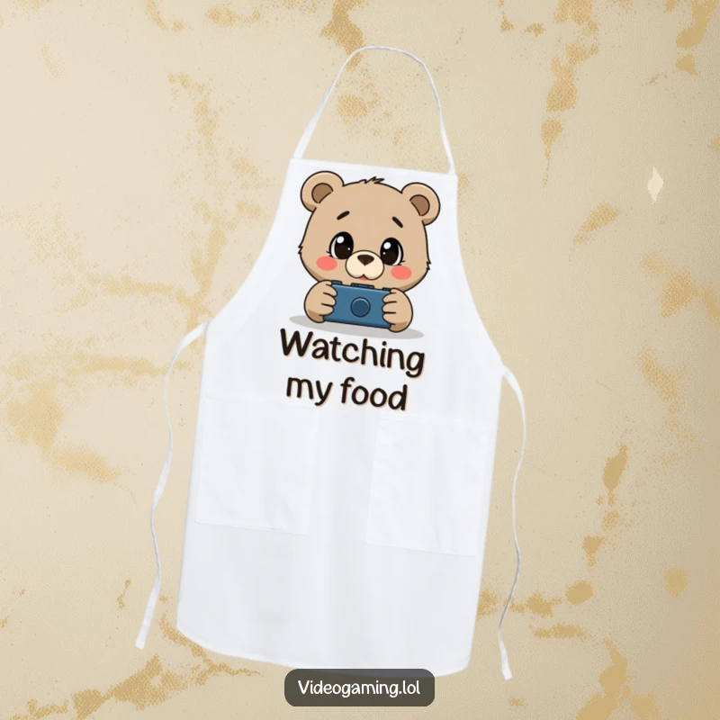 Funny apron featuring a curious bear with wide, amazed eyes watching a screen, ideal for kitchen gaming fans.